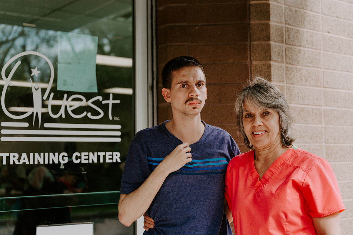 Quest, Inc. - Michael and Mom In Front of Entrance of Training Center