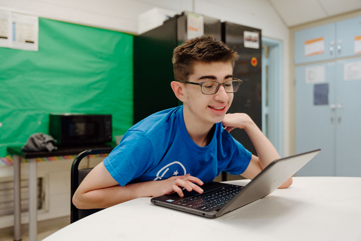 Photo of QKA student Daniel on his laptop.