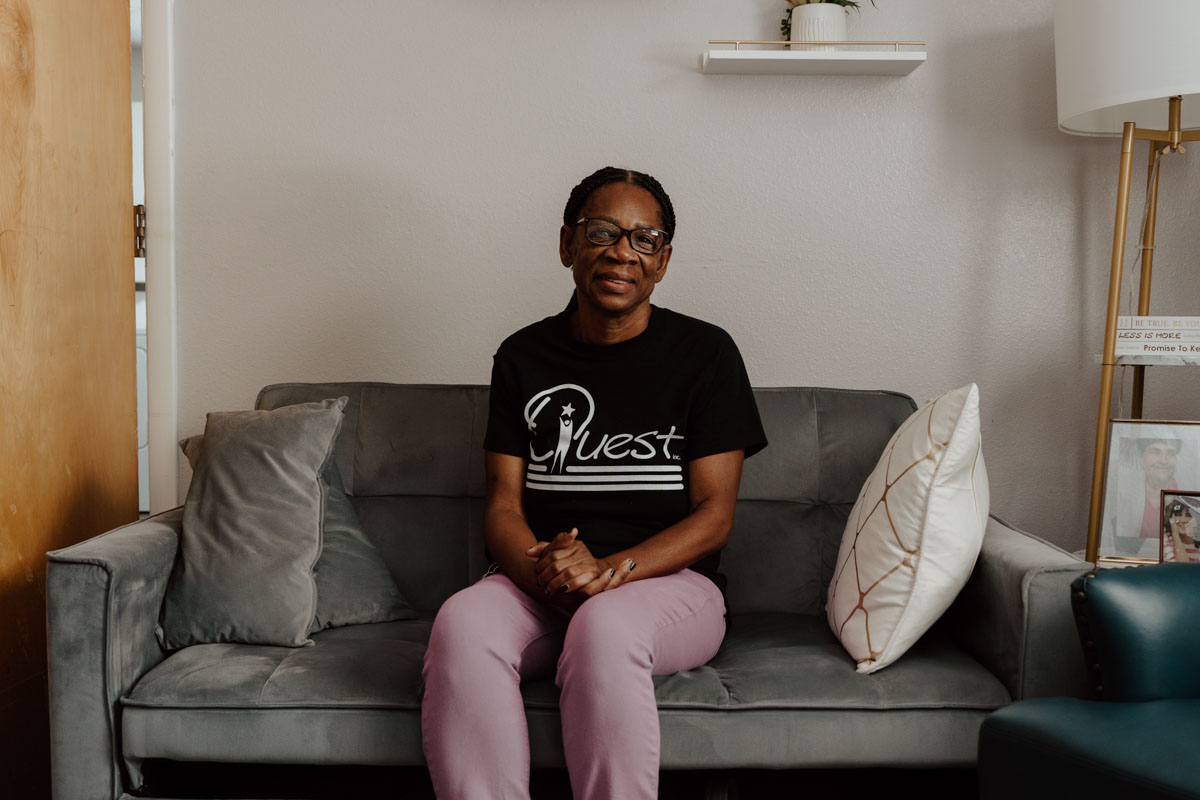 Eileen Neal posing on the sofa at Quest's Group Home in Piedmont.