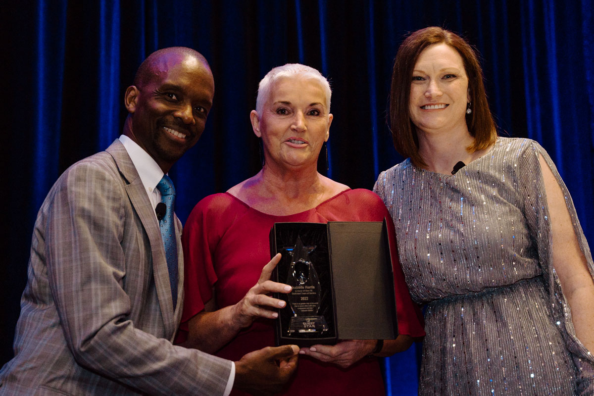 Photo of Isabelle with Quest leadership receiving her Quest Stars award.