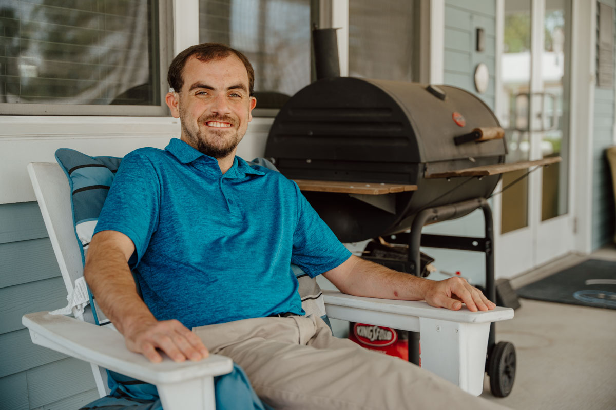 Photo of Hart sitting outside of his apartment.