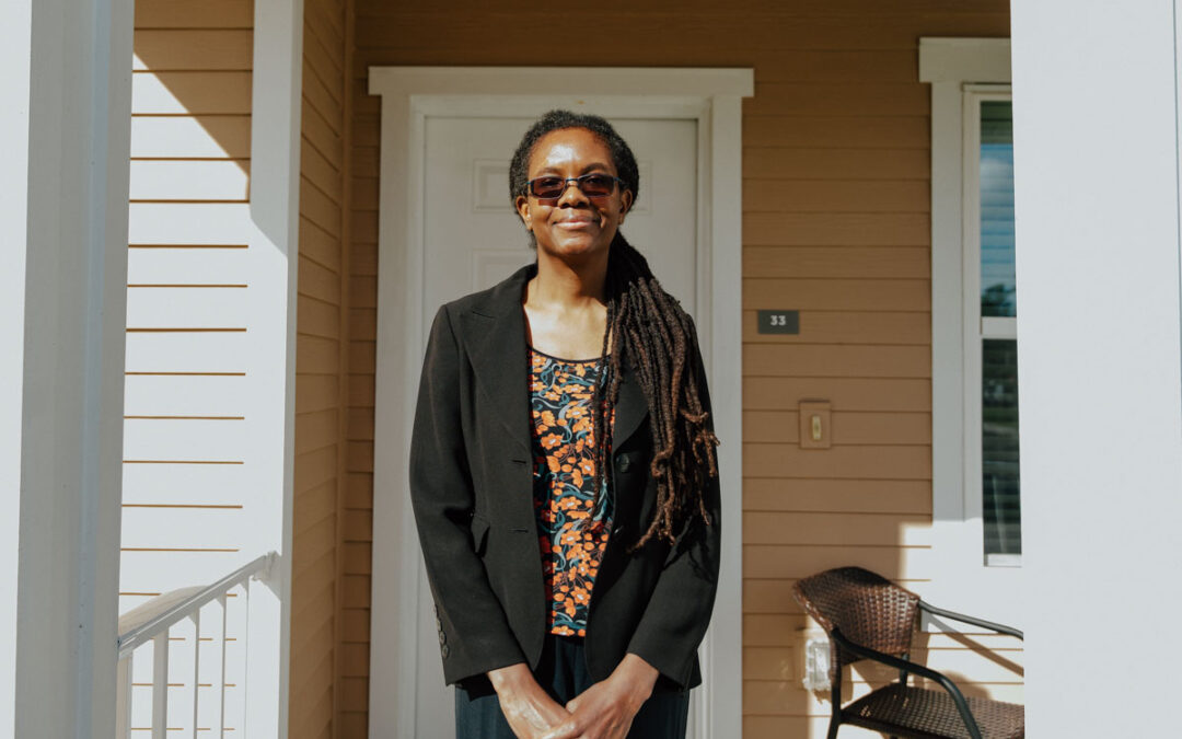 Kamisheba posing in front of her apartment at Quest Village.