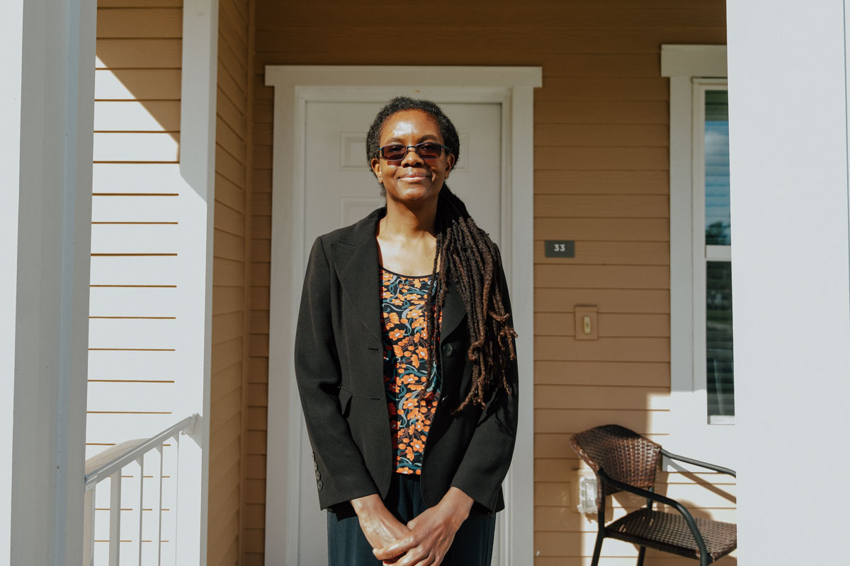 Kamisheba posing in front of her apartment at Quest Village.