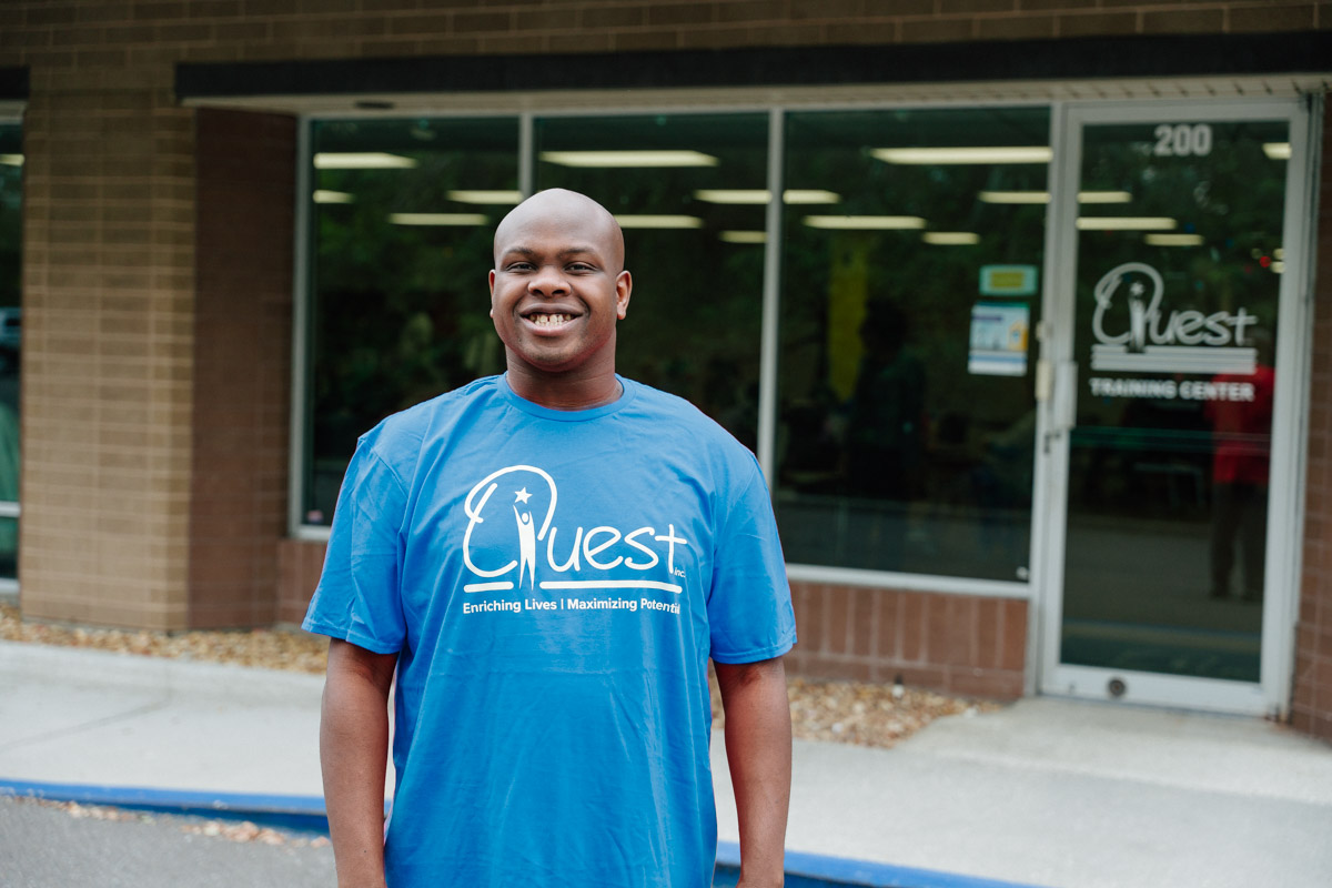 A photo of Prentice smiling in front of Quest's Training Center in Tampa.