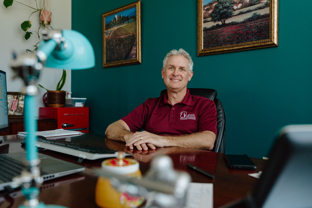 Photo of Todd sitting in his office at Quest, Inc.