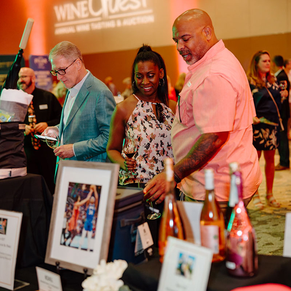 Server pouring drink at Wine Quest dinner.