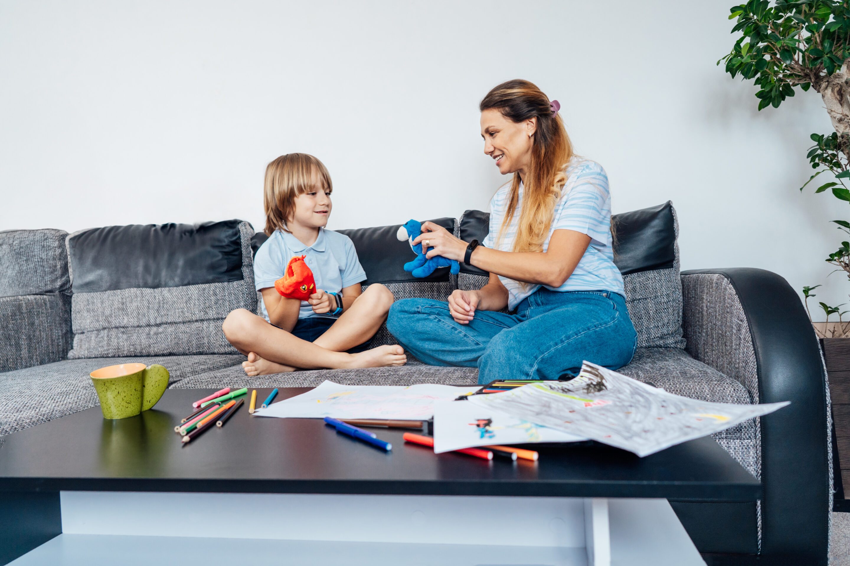 Happy mother and son working on aba therapy goal together